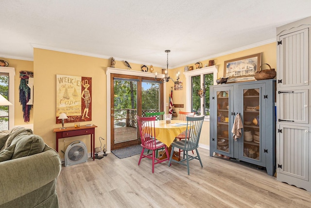 8870 W School Section Lake Dr, Mecosta, MI 49332 - dining space featuring light wood finished floors and ornamental molding
