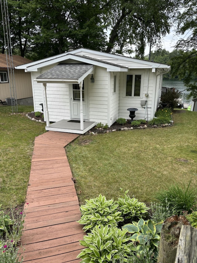8870 W School Section Lake Dr, Mecosta, MI 49332 - rear view of property with a lawn and roof with shingles