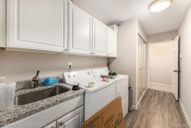 6548 Shetland Ct, Shelby Twp, MI 48316 - laundry room with washer and clothes dryer, dark wood-style flooring, and cabinet space