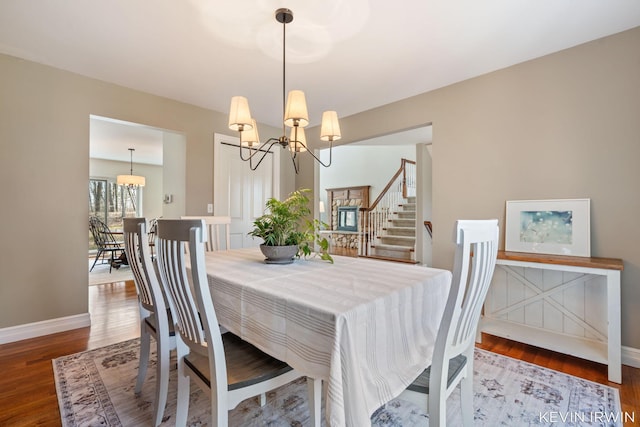 19223 Fox Glove Cir, Big Rapids, MI 49307 - dining room featuring a chandelier, wood finished floors, and stairs