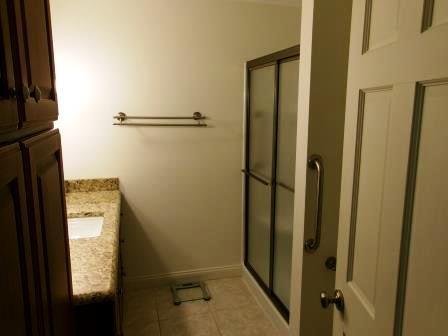 44 N Main St, Quincy, MI 49082 - full bathroom with vanity, a stall shower, and tile patterned flooring