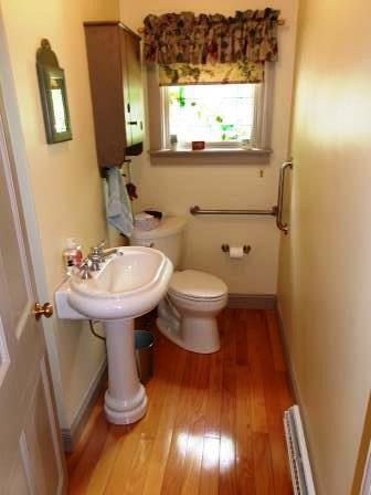 44 N Main St, Quincy, MI 49082 - bathroom featuring wood finished floors and toilet