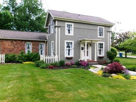 44 N Main St, Quincy, MI 49082 - rear view of house with a lawn
