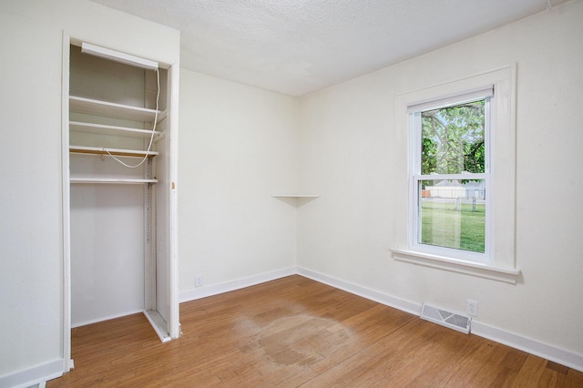 8464 E Michigan Ave, Galesburg, MI 49053 - unfurnished bedroom with light wood finished floors and a closet