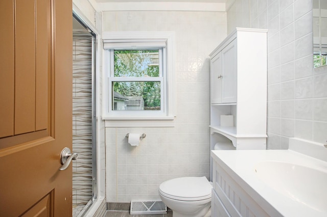 8464 E Michigan Ave, Galesburg, MI 49053 - bathroom featuring tile walls, vanity, a shower with shower door, and tile patterned floors