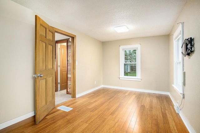 8464 E Michigan Ave, Galesburg, MI 49053 - spare room with light wood-style flooring and a textured ceiling
