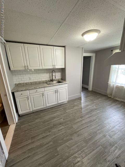 2135 Jarvis Ave, Warren, MI 48091 - kitchen with white cabinetry, dark wood finished floors, and backsplash