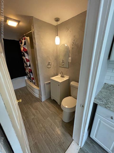 2135 Jarvis Ave, Warren, MI 48091 - full bathroom with vanity, wood finished floors, and curtained shower