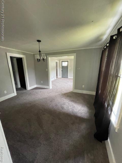 2135 Jarvis Ave, Warren, MI 48091 - unfurnished living room featuring a chandelier, dark colored carpet, and crown molding