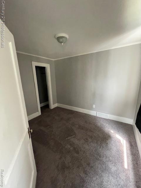 2135 Jarvis Ave, Warren, MI 48091 - spare room featuring dark colored carpet and ornamental molding