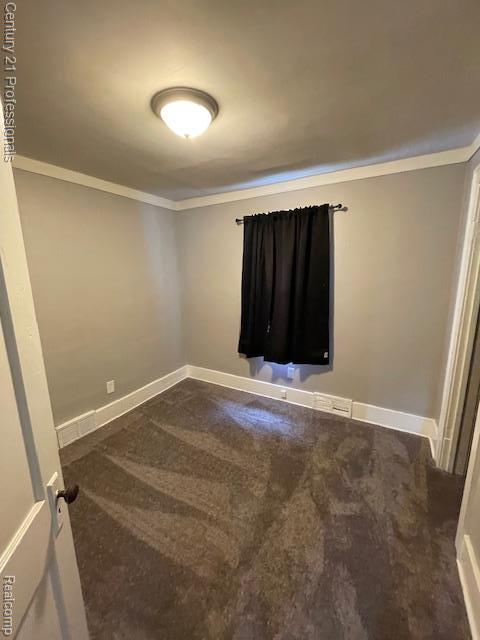 2135 Jarvis Ave, Warren, MI 48091 - spare room with ornamental molding and dark colored carpet