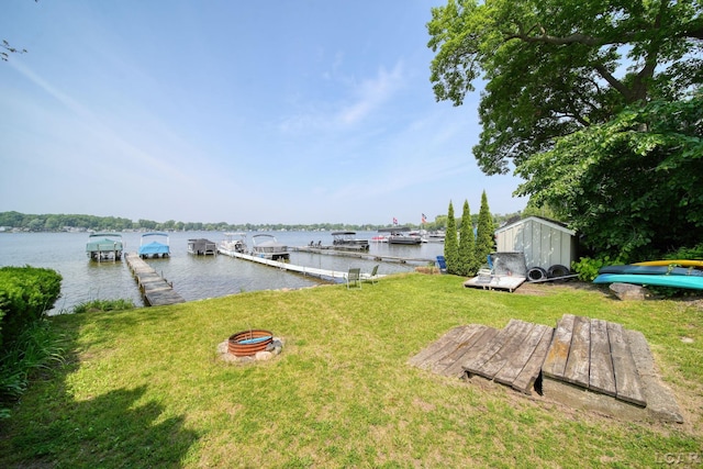 5027 Belemere Ct, Manitou Beach, MI 49253 - dock with a water view, a yard, and a fire pit