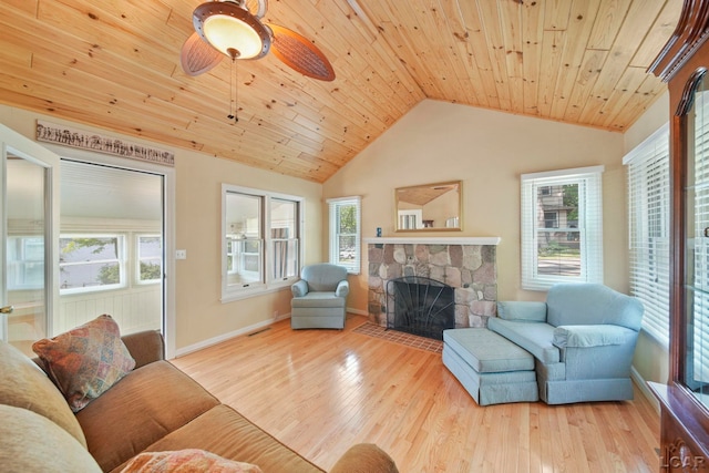 5027 Belemere Ct, Manitou Beach, MI 49253 - living area with a ceiling fan, vaulted ceiling, a stone fireplace, wood ceiling, and wood finished floors
