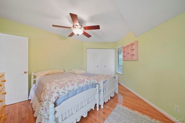 5027 Belemere Ct, Manitou Beach, MI 49253 - bedroom with a closet, wood finished floors, and a ceiling fan