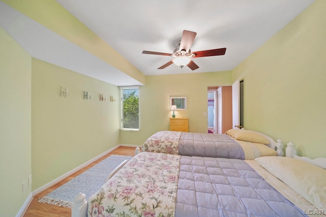 5027 Belemere Ct, Manitou Beach, MI 49253 - bedroom with wood finished floors and a ceiling fan