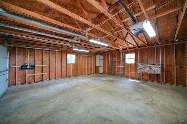 5027 Belemere Ct, Manitou Beach, MI 49253 - garage featuring a garage door opener