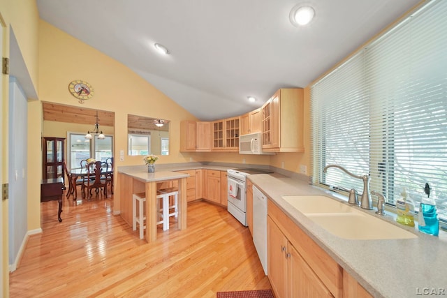 5027 Belemere Ct, Manitou Beach, MI 49253 - kitchen featuring white appliances, light brown cabinetry, glass insert cabinets, lofted ceiling, and a kitchen bar
