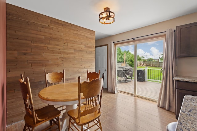 7673 Dalton Rd, Onsted, MI 49265 - dining space featuring wooden walls and light wood-style floors