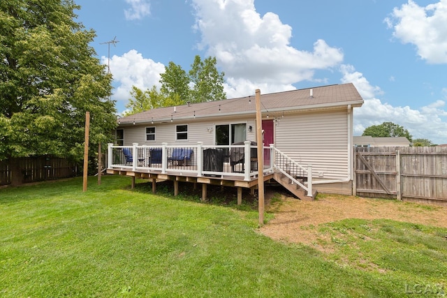7673 Dalton Rd, Onsted, MI 49265 - back of property with a fenced backyard and a wooden deck