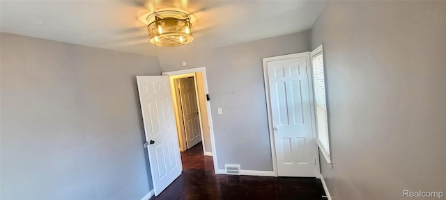 18978 Indiana St, Detroit, MI 48221 - unfurnished bedroom featuring dark wood-style floors and a closet