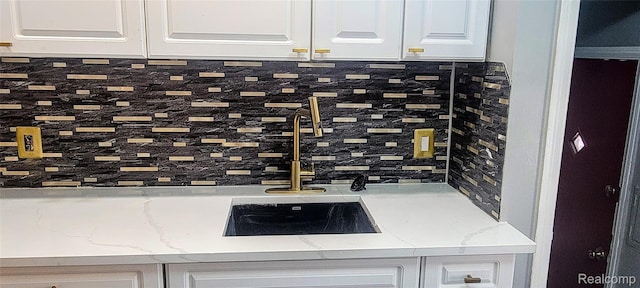 18978 Indiana St, Detroit, MI 48221 - kitchen view of backsplash, white cabinetry, and light stone countertops