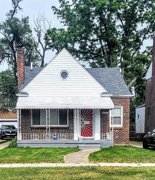 18978 Indiana St, Detroit, MI 48221 - bungalow-style house with brick siding, a shingled roof, and a chimney