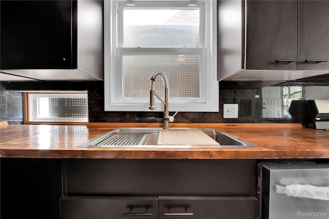 20120 Norwood St, Detroit, MI 48234 - kitchen featuring butcher block countertops, stainless steel dishwasher, and plenty of natural light