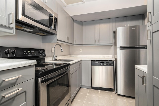 3539 Kenbrooke Ct, Kalamazoo, MI 49006 - kitchen with stainless steel appliances, gray cabinets, light countertops, and light tile patterned floors