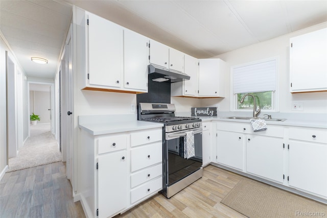 5806 Commanche Ln, Howell, MI 48843 - kitchen featuring stainless steel gas stove, under cabinet range hood, light wood finished floors, light countertops, and white cabinets