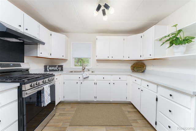 5806 Commanche Ln, Howell, MI 48843 - kitchen featuring stainless steel gas range, under cabinet range hood, open shelves, and light wood finished floors