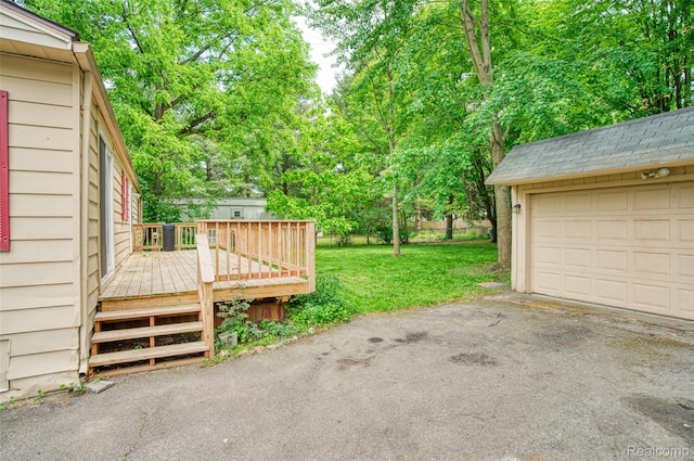 5806 Commanche Ln, Howell, MI 48843 - view of green lawn with a deck, a garage, and view of scattered trees