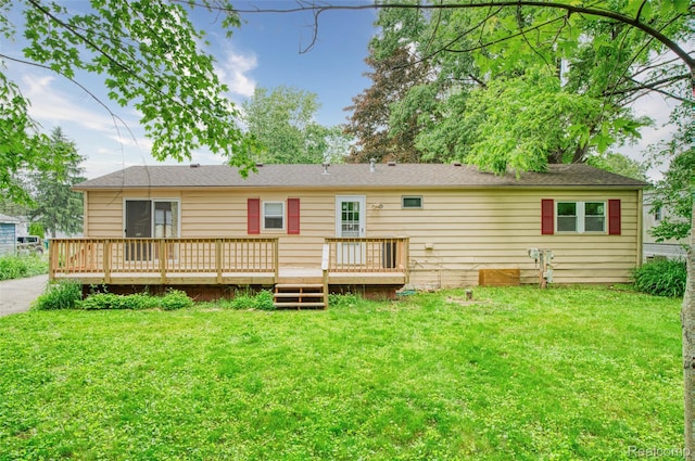 5806 Commanche Ln, Howell, MI 48843 - back of property with a yard and a wooden deck