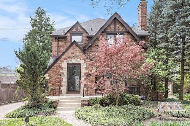 1506 Shadford Rd, Ann Arbor, MI 48104 - tudor home with a chimney, brick siding, and roof with shingles