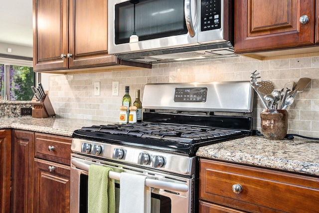 1506 Shadford Rd, Ann Arbor, MI 48104 - kitchen featuring appliances with stainless steel finishes, decorative backsplash, light stone counters, and brown cabinets