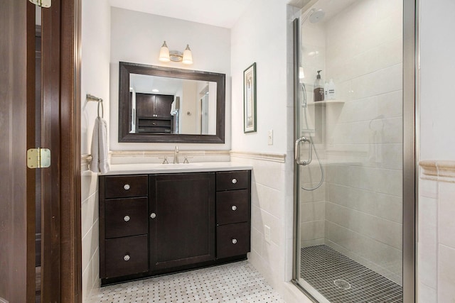1506 Shadford Rd, Ann Arbor, MI 48104 - full bathroom with a shower stall, wainscoting, vanity, and tile walls