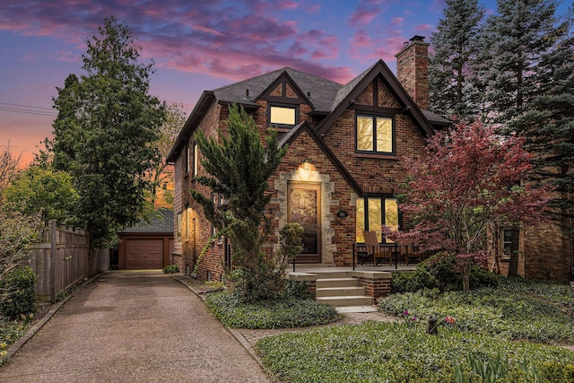 1506 Shadford Rd, Ann Arbor, MI 48104 - tudor home with driveway, a chimney, brick siding, and a shingled roof