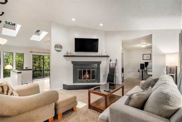 4760 Briarhill Dr, Portage, MI 49024 - living room with a skylight, a glass covered fireplace, vaulted ceiling, carpet, and recessed lighting