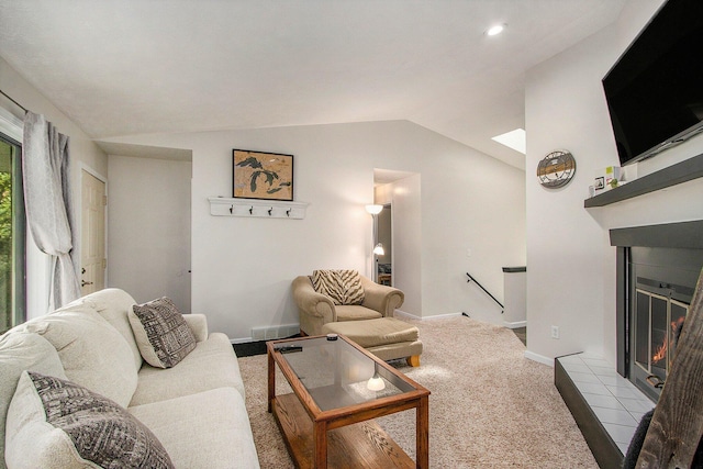 4760 Briarhill Dr, Portage, MI 49024 - living room featuring a tile fireplace, lofted ceiling, and carpet floors