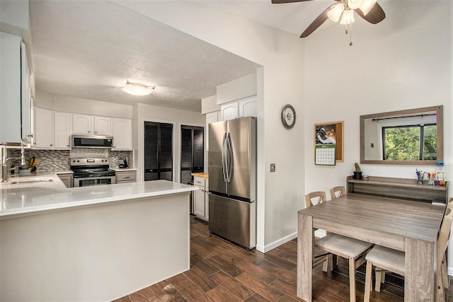 4760 Briarhill Dr, Portage, MI 49024 - kitchen featuring appliances with stainless steel finishes, backsplash, a peninsula, light countertops, and ceiling fan