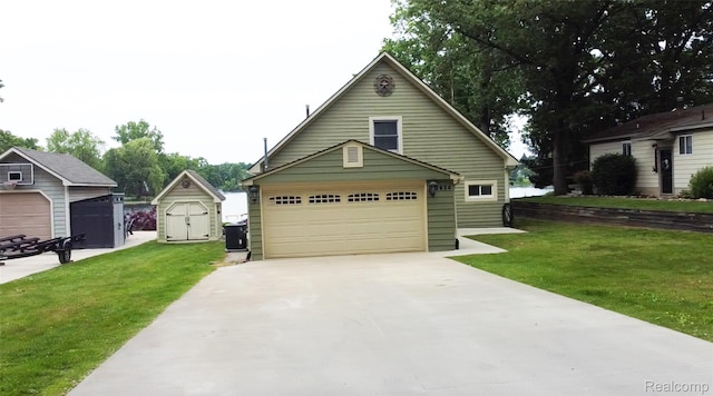 2624 Lynch, Highland, MI 48357 - view of front of home featuring a garage, a front lawn, an outdoor structure, and concrete driveway