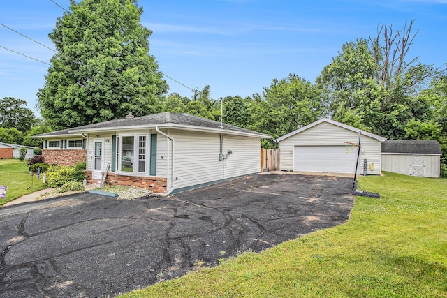 201 Beaumont Dr, Battle Creek, MI 49014 - view of front of house with an outdoor structure, a detached garage, brick siding, a front lawn, and entry steps