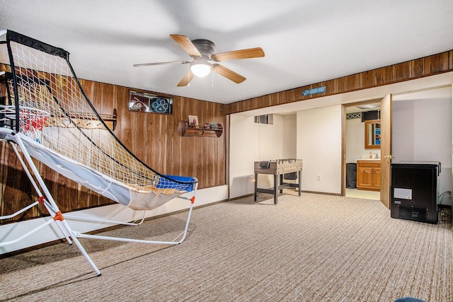201 Beaumont Dr, Battle Creek, MI 49014 - game room featuring ceiling fan, wooden walls, and carpet flooring