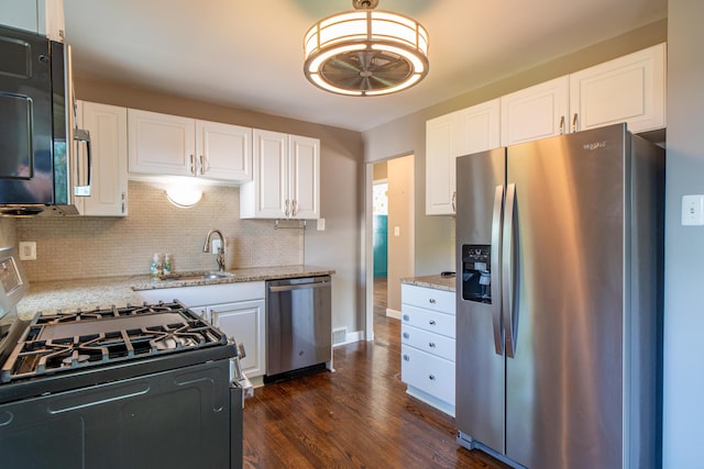 4211 Oakshire Ave, Berkley, MI 48072 - kitchen with stainless steel appliances, backsplash, light stone counters, dark wood finished floors, and white cabinetry