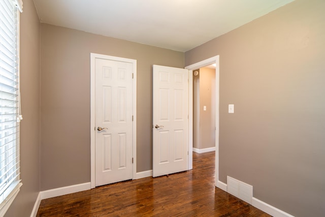 4211 Oakshire Ave, Berkley, MI 48072 - unfurnished bedroom with wood finished floors and multiple windows