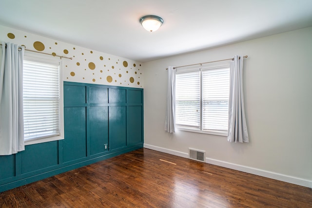 4211 Oakshire Ave, Berkley, MI 48072 - unfurnished bedroom featuring wallpapered walls and dark wood-type flooring