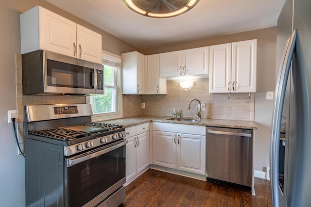4211 Oakshire Ave, Berkley, MI 48072 - kitchen with stainless steel appliances, dark wood-style floors, light stone countertops, and decorative backsplash