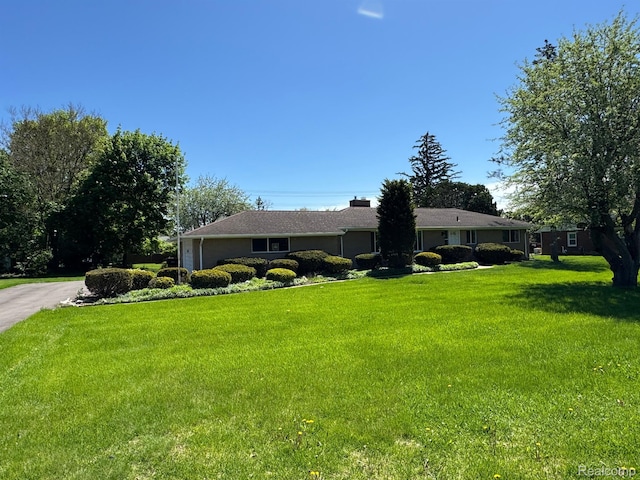 28670 Inkster Rd, Southfield, MI 48034 - ranch-style house featuring a front lawn, a chimney, an attached garage, and driveway