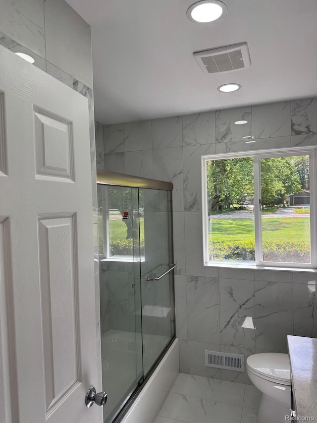 28670 Inkster Rd, Southfield, MI 48034 - full bath with marble look tiles, healthy amount of natural light, bath / shower combo with glass door, and recessed lighting