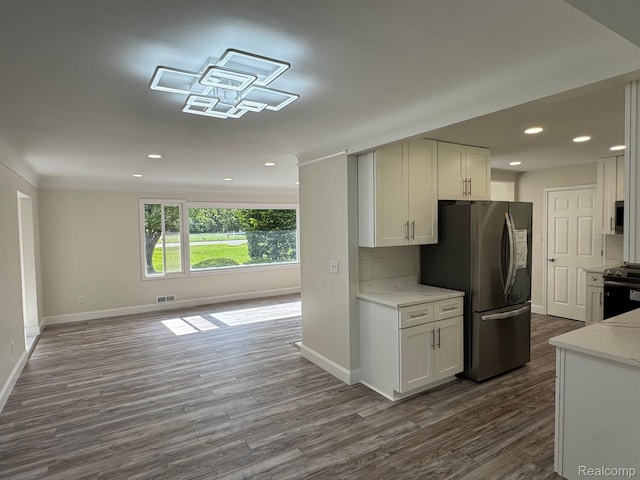 28670 Inkster Rd, Southfield, MI 48034 - kitchen featuring appliances with stainless steel finishes, dark wood-type flooring, white cabinets, light stone countertops, and recessed lighting