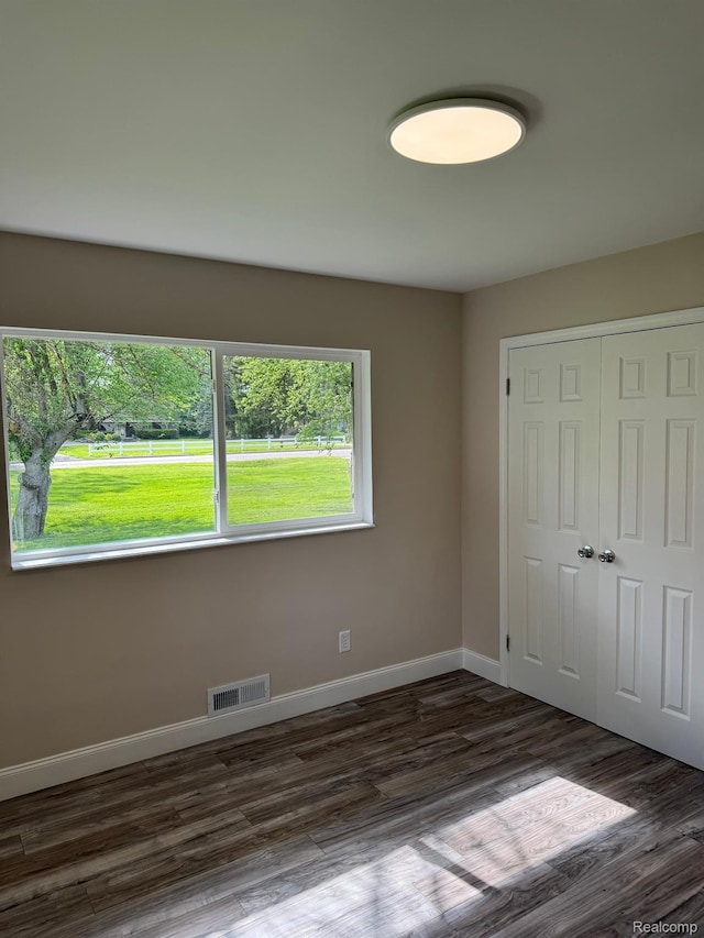 28670 Inkster Rd, Southfield, MI 48034 - unfurnished bedroom featuring a closet and dark wood-style floors
